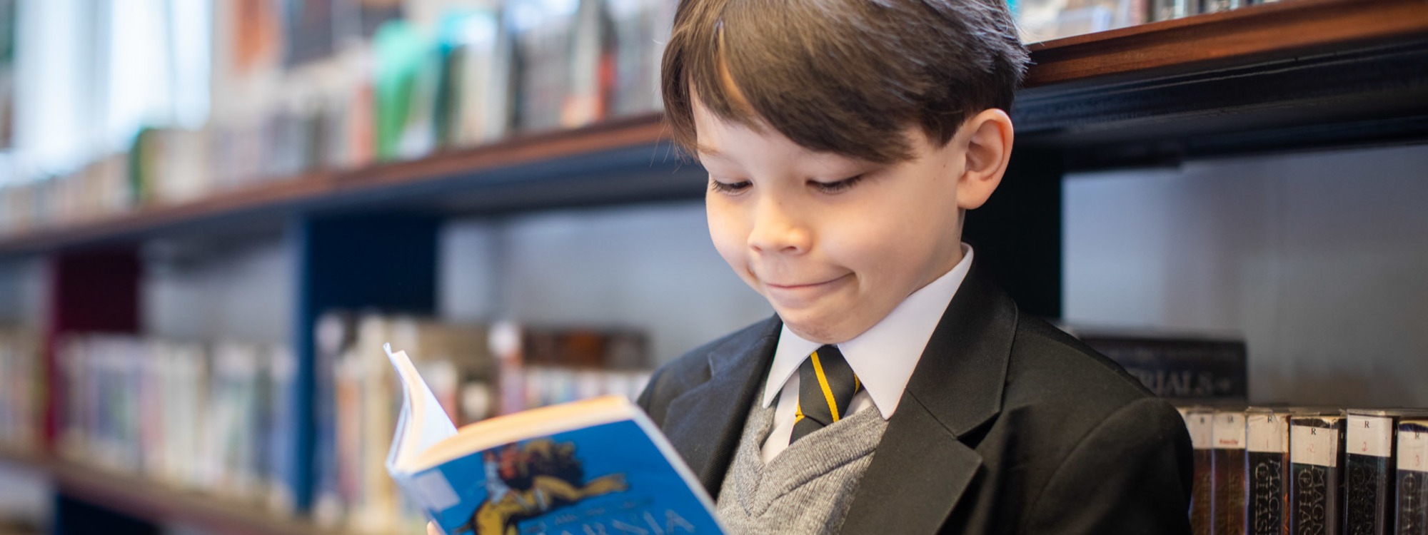 Year 7 pupil reading Narnia
